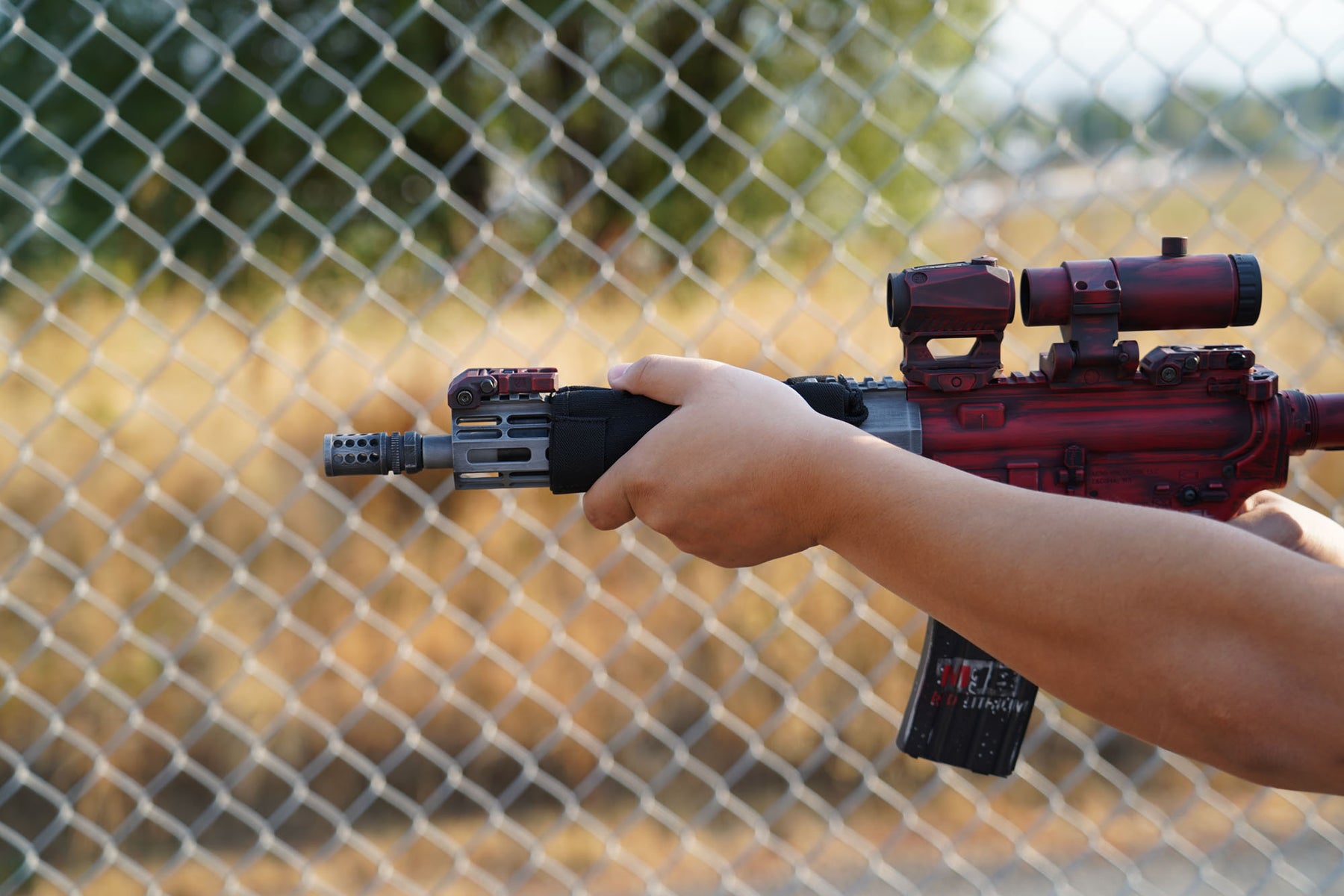 a close up of a person holding a baseball bat 