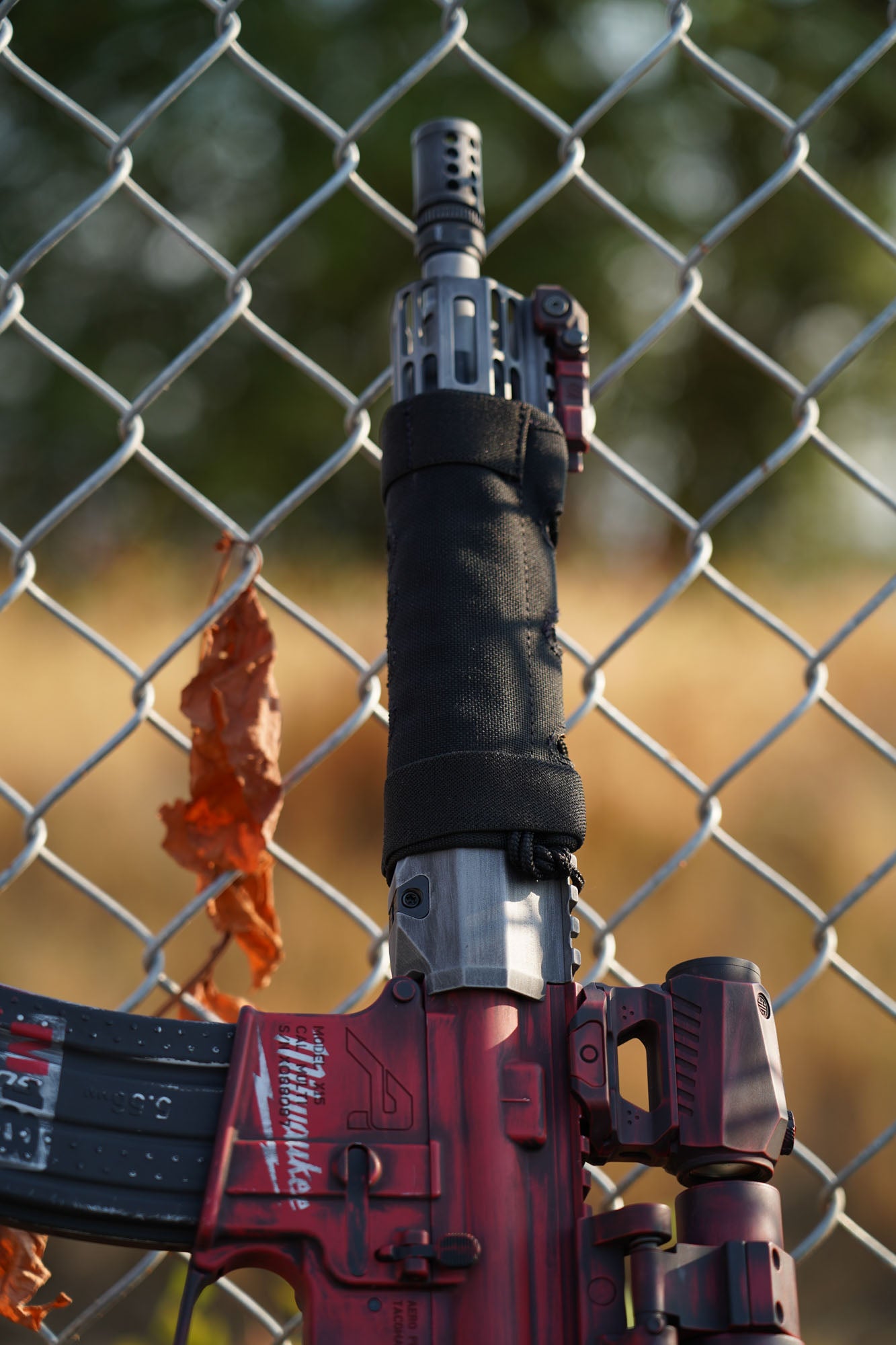 a fire hydrant in front of a chain link fence