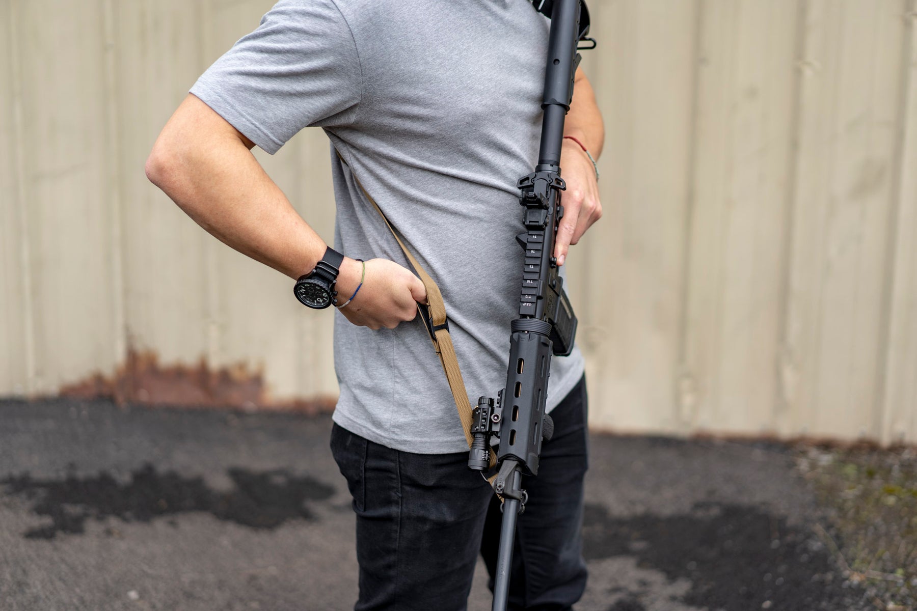 a man is holding a baseball bat on a sidewalk 