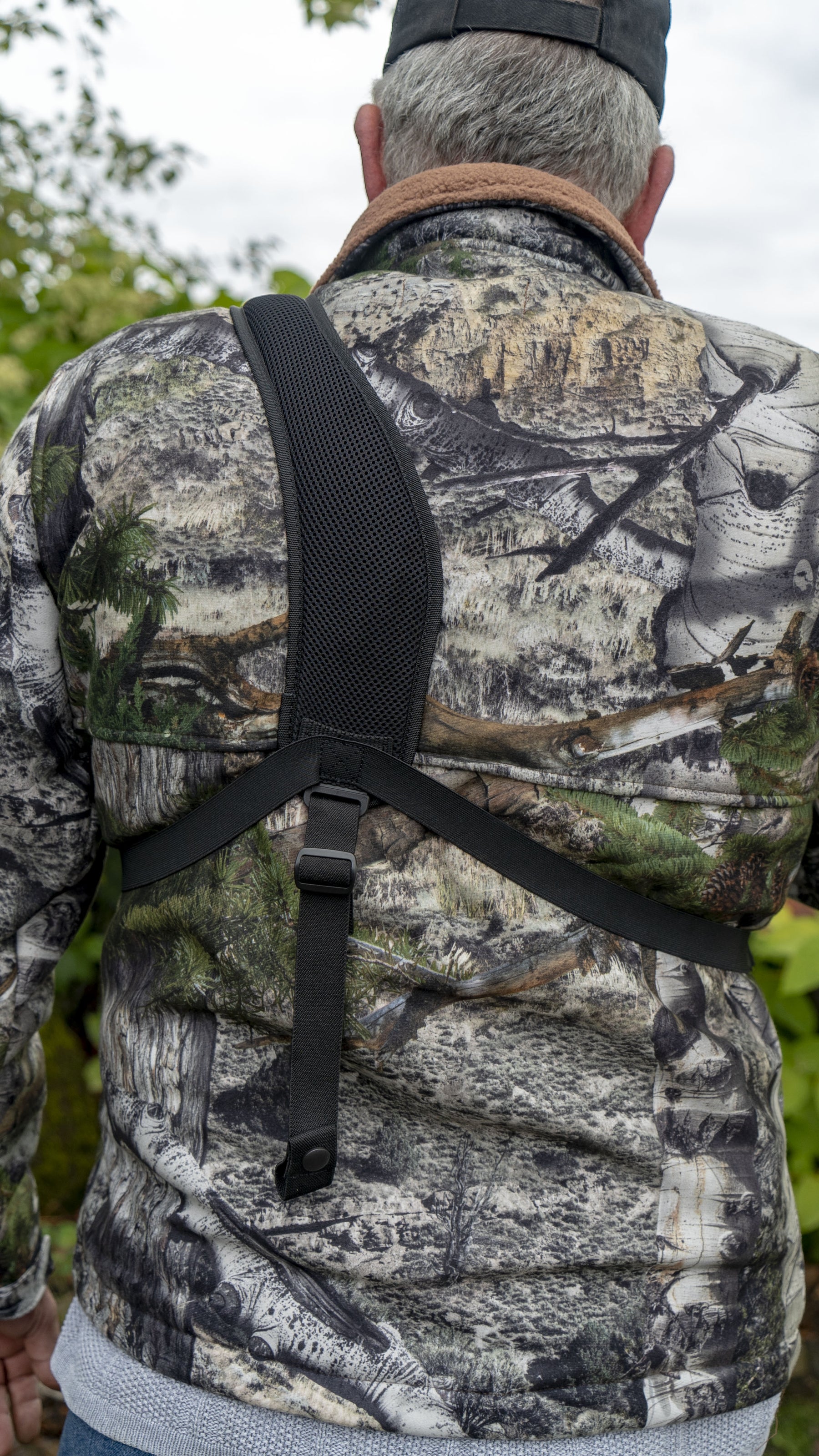 a person standing next to a rock