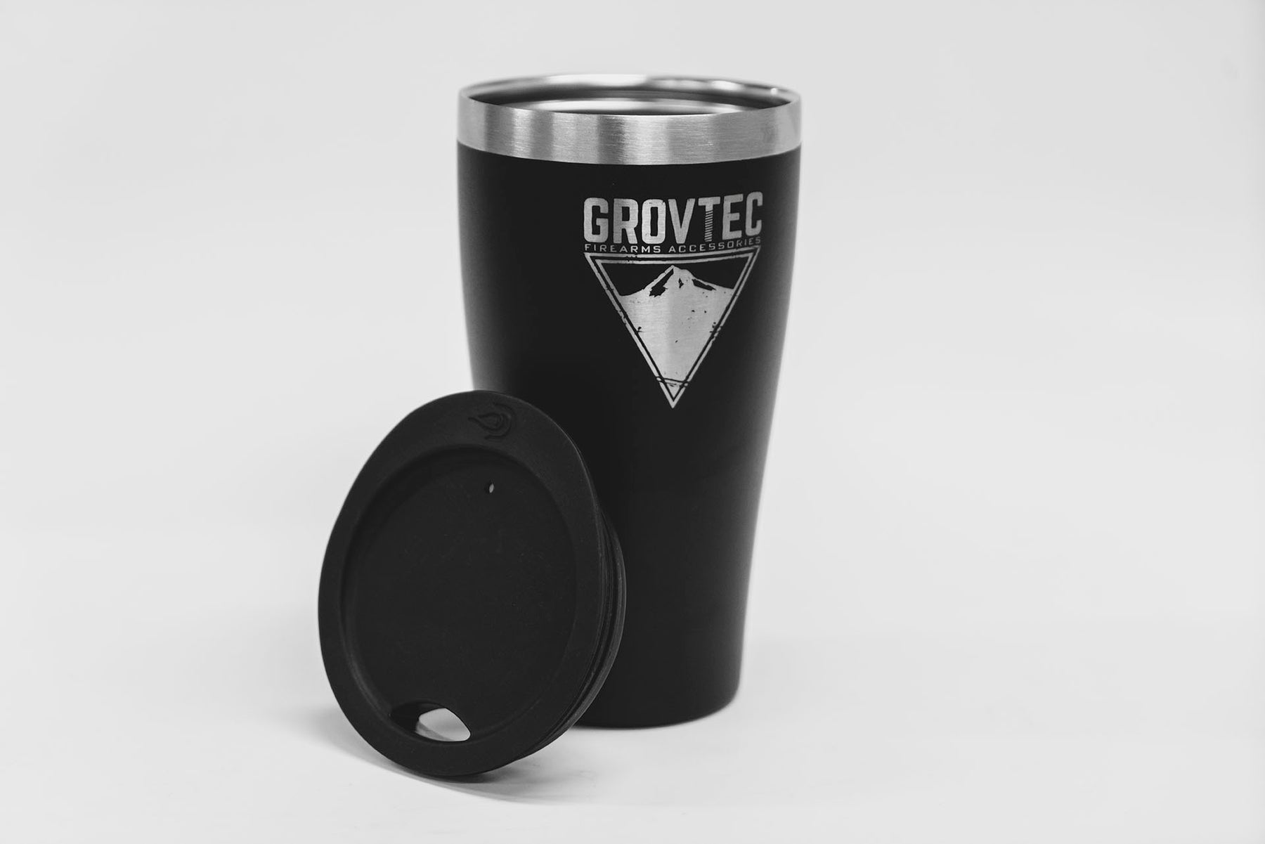 a black coffee cup sitting next to a cell phone