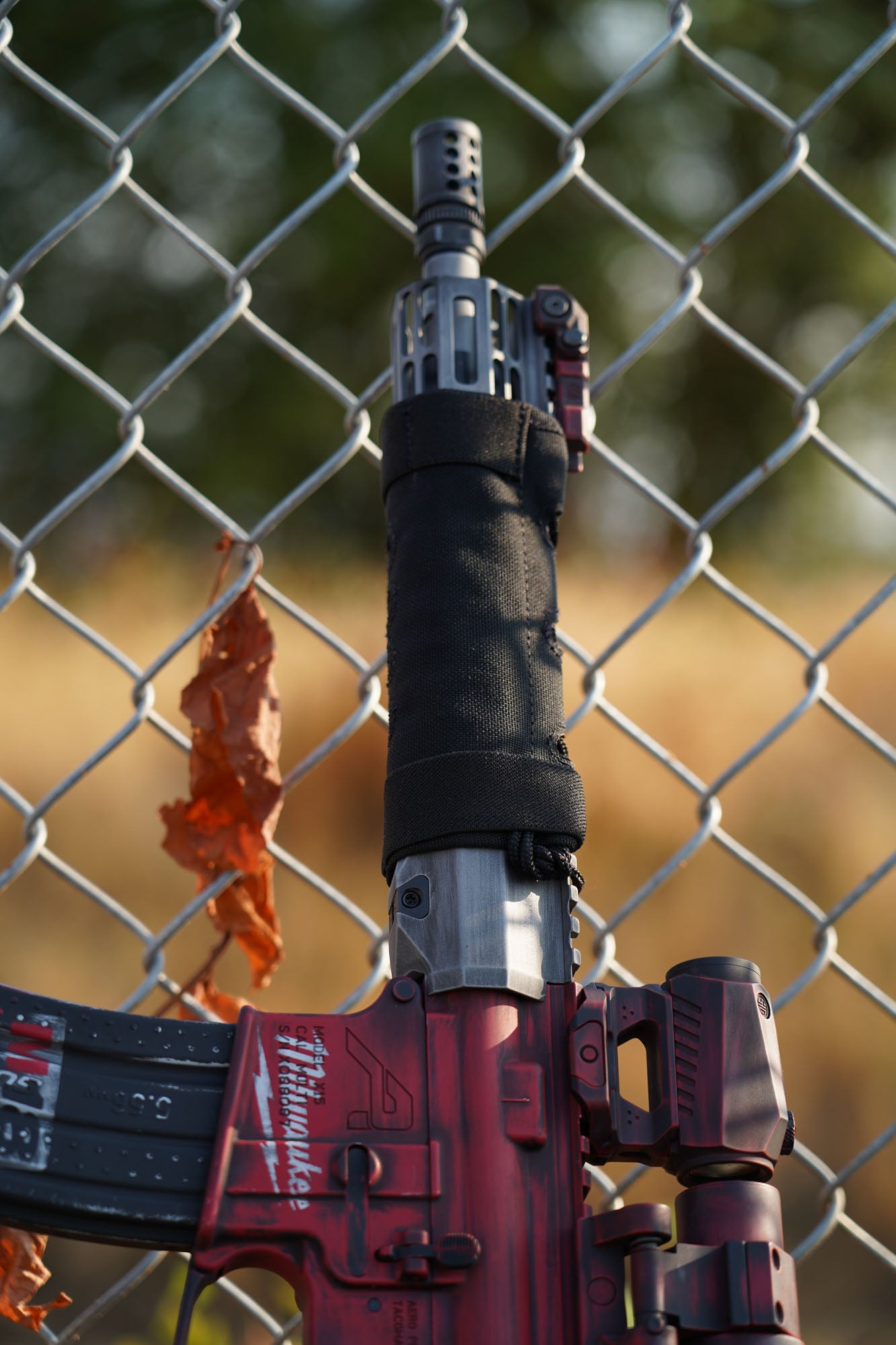 a fire hydrant in front of a chain link fence 